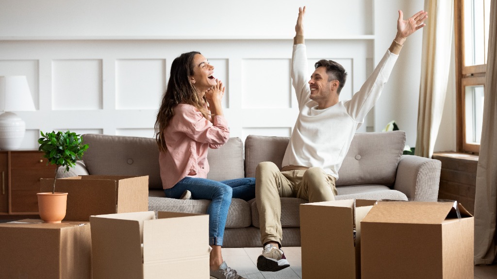 Couple happily celebrating moving into their new home