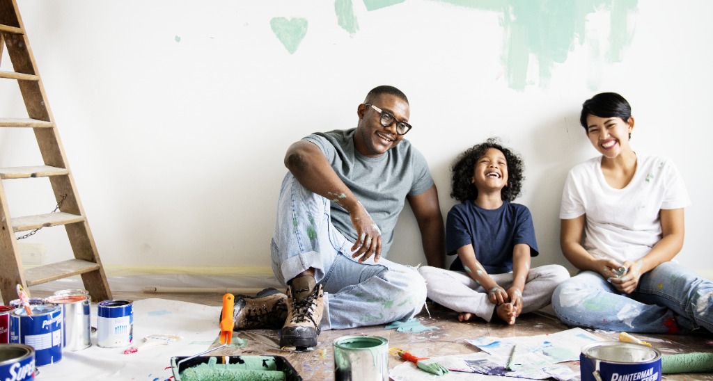 Family painting their new home together