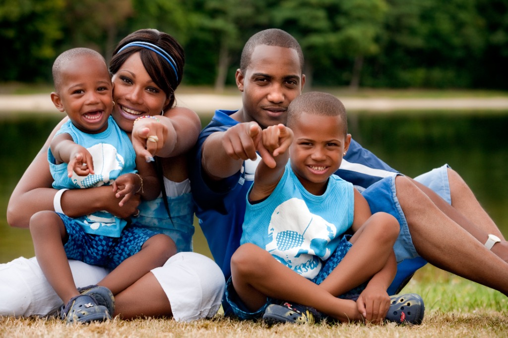 Happy family smiling together outdoors while finding their new home